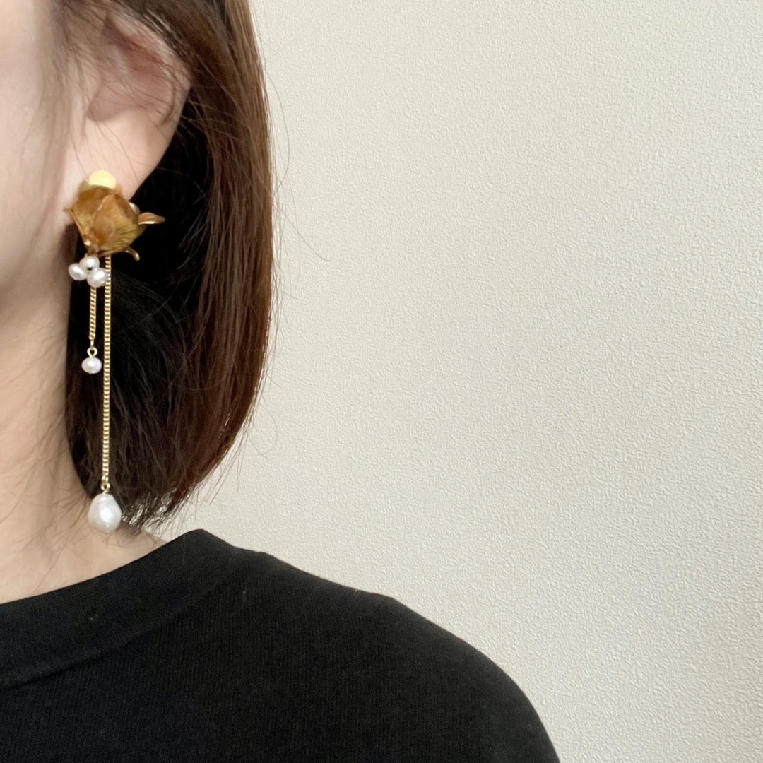 woman wearing 18K gold plated floral pearl earrings, elegant long dangle design