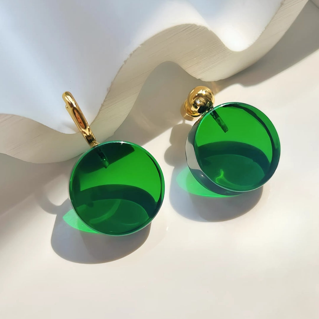 Detailed view of the hoop and stud versions of translucent green glass earrings with nickel-free stainless steel posts.