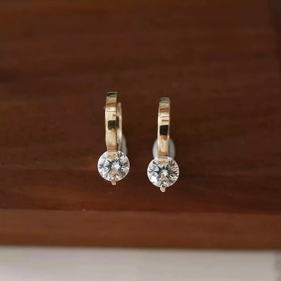 14K real gold hoop earrings with clear zircon on a wooden surface