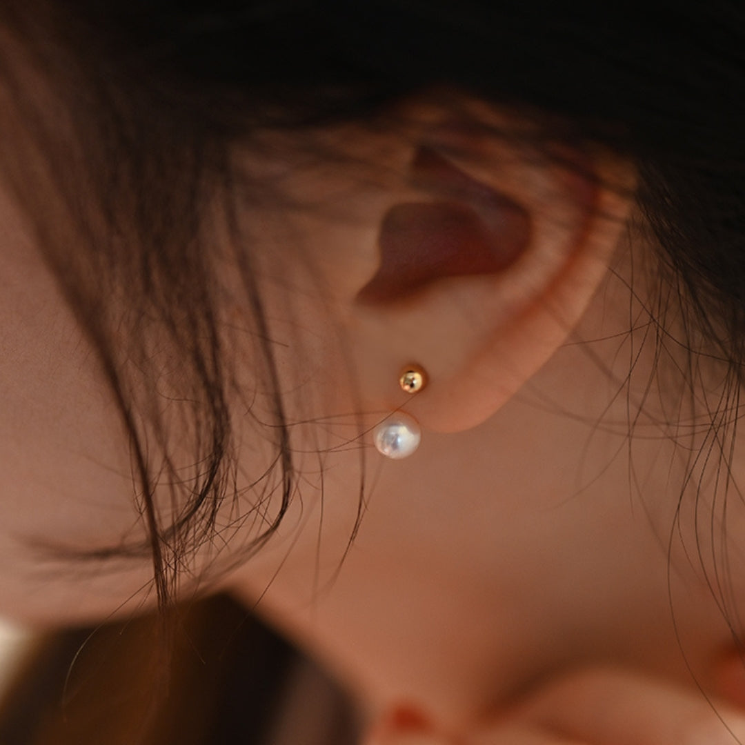 woman wearing 18K gold plated freshwater pearl stud earrings by Lollimix