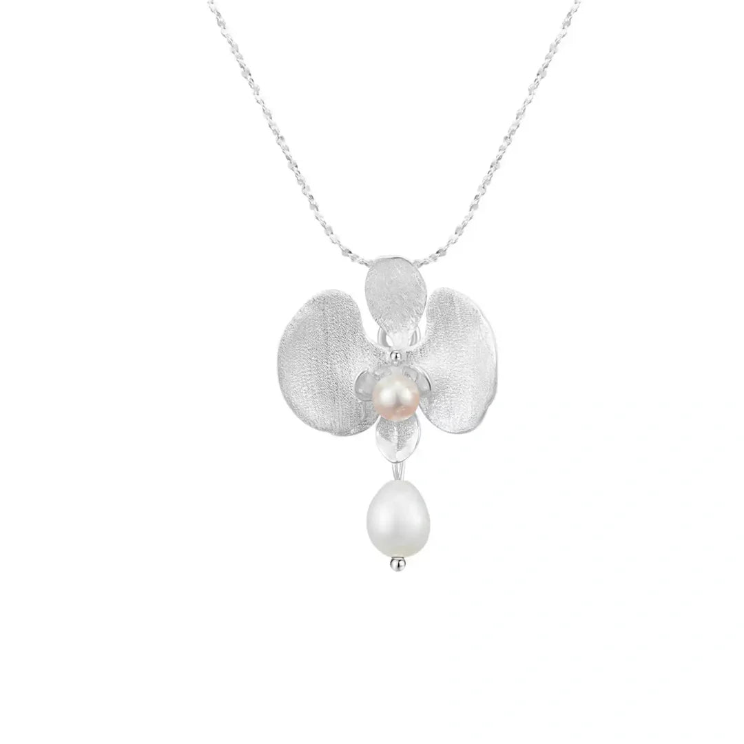 Botanical Realism Sterling Silver and Freshwater Pearl orchid pendant isolated on white background.