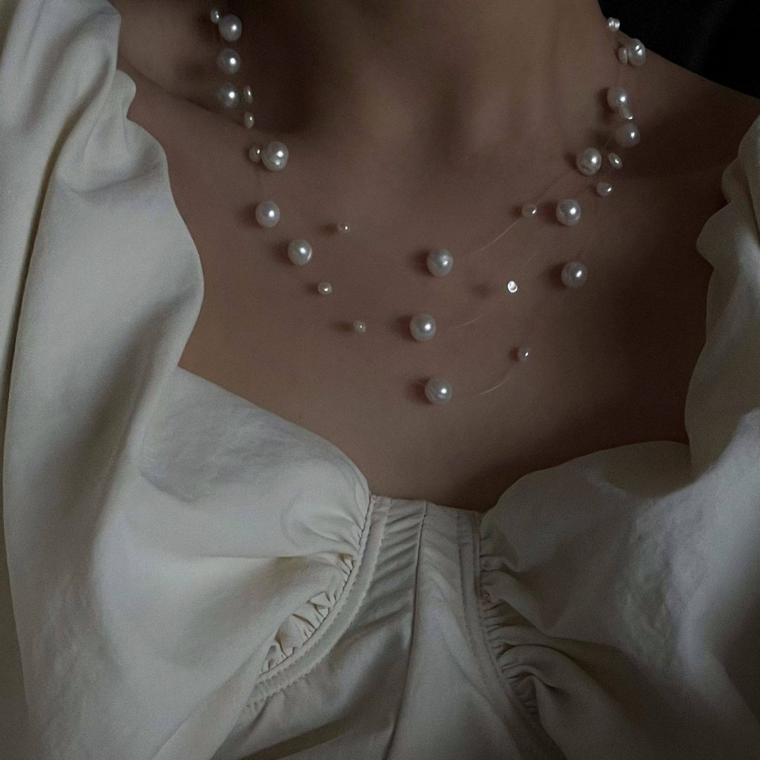 Illusion Floating Pearl elegant vintage natural freshwater pearl necklace enhancing neckline with a white romantic blouse - model-look-2