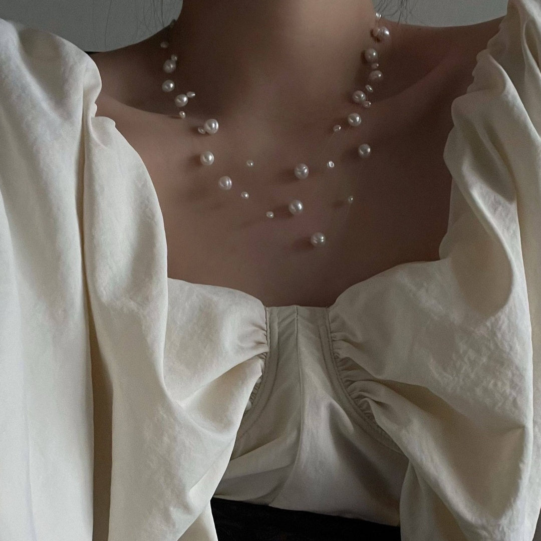 Illusion Floating Pearl elegant vintage natural freshwater pearl necklace enhancing neckline with a white romantic blouse - model-look-3