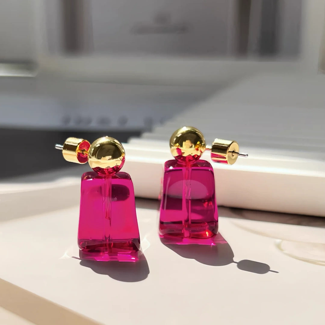 Magenta glass ice cube earrings with 18k gold plated hoops on white background