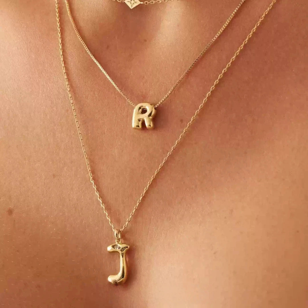 Two layered mini bubble letter pendants J and R, personalized gold jewelry for effortless layering.