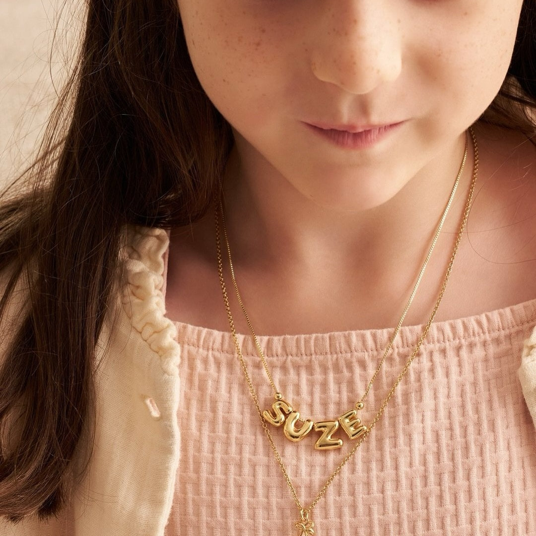 Size reference of mini 1cm 3D puffed initial pendant in polished gold finish. 2