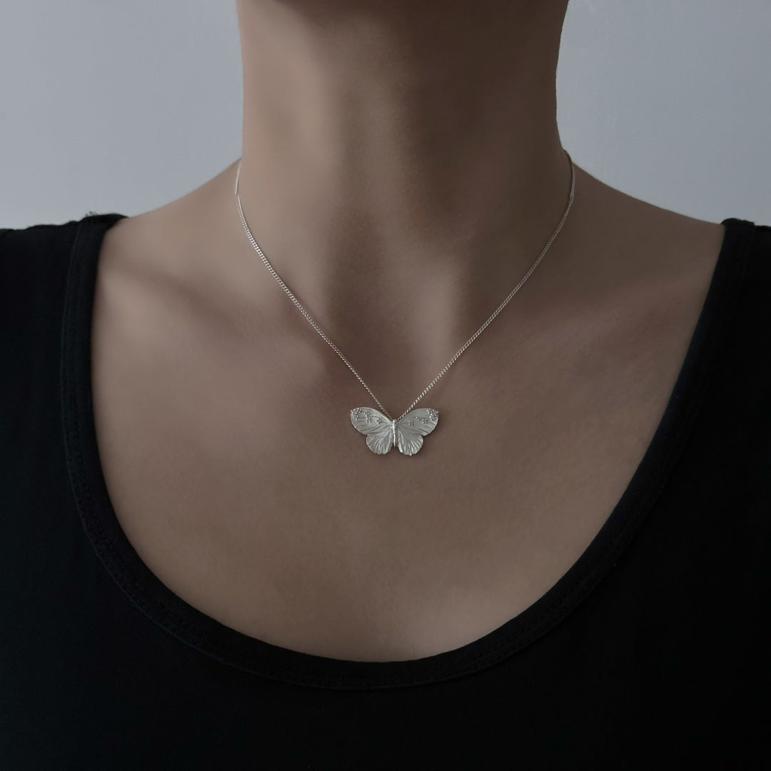 Textured Wing butterfly necklace in S925 sterling silver worn by a model to show the elegant collarbone fit - model-look-3