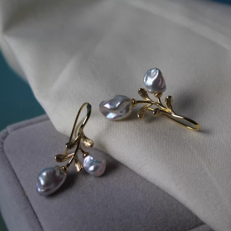 Side view of the ear hook design featuring high-quality baroque pearls with natural shimmering lusters.